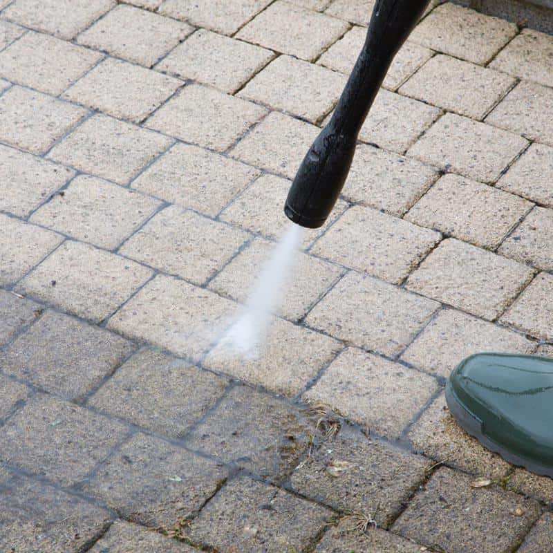 Clean the driveway with a pressure washer